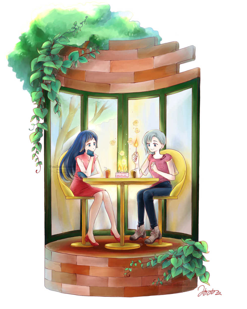 2人の女の子がカフェで一緒/バースデーケーキにろうそくを立てて火をつける